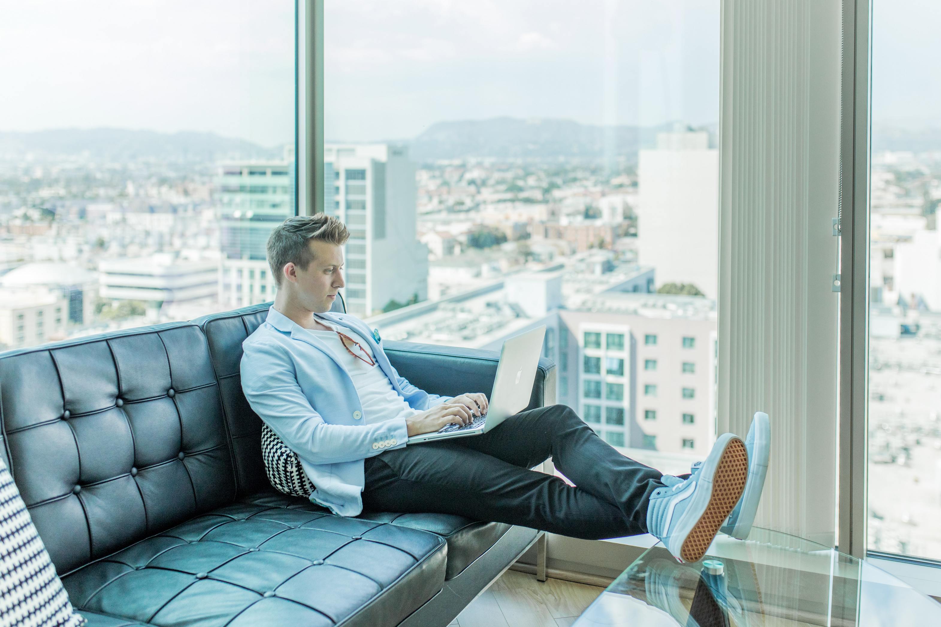 Man sitting with laptop and working remotely